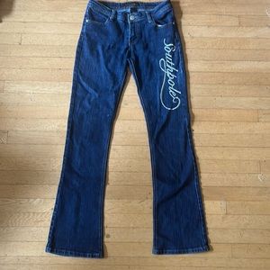 womens boot cut dark wash jeans with south pole embroidered down the leg.
